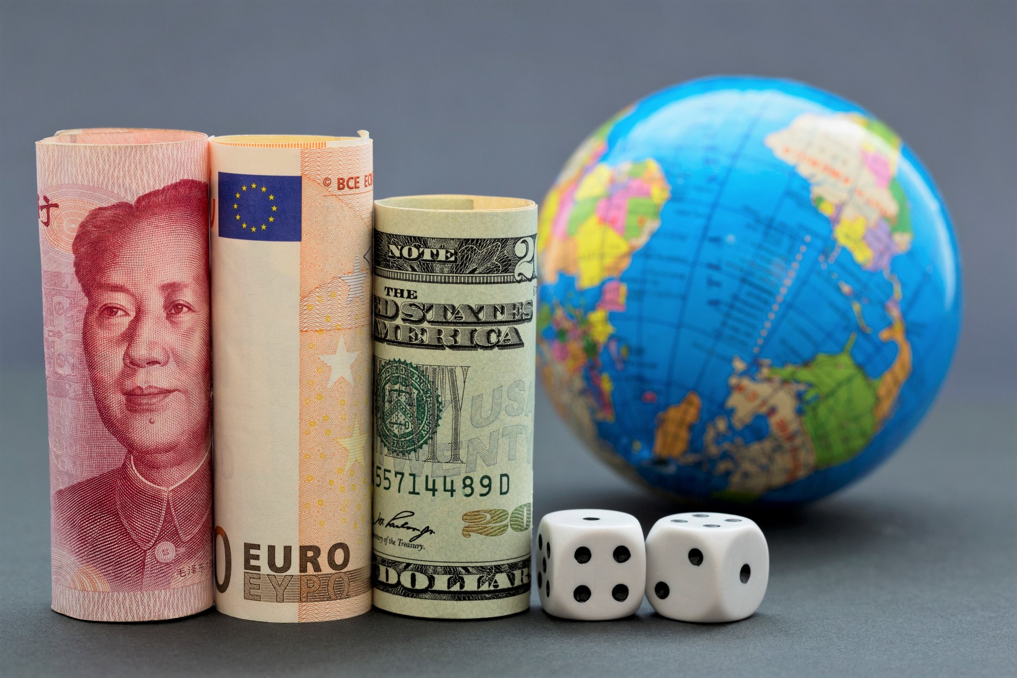 International money, dice, and a small globe