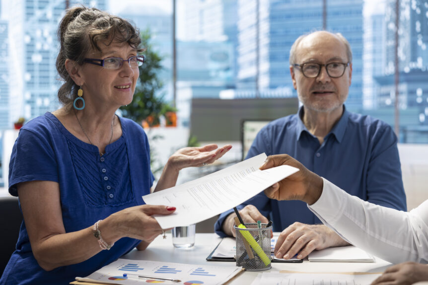 A couple reviewing financial documents, symbolizing the importance of adjusting retirement planning for 2025 tax bracket changes.