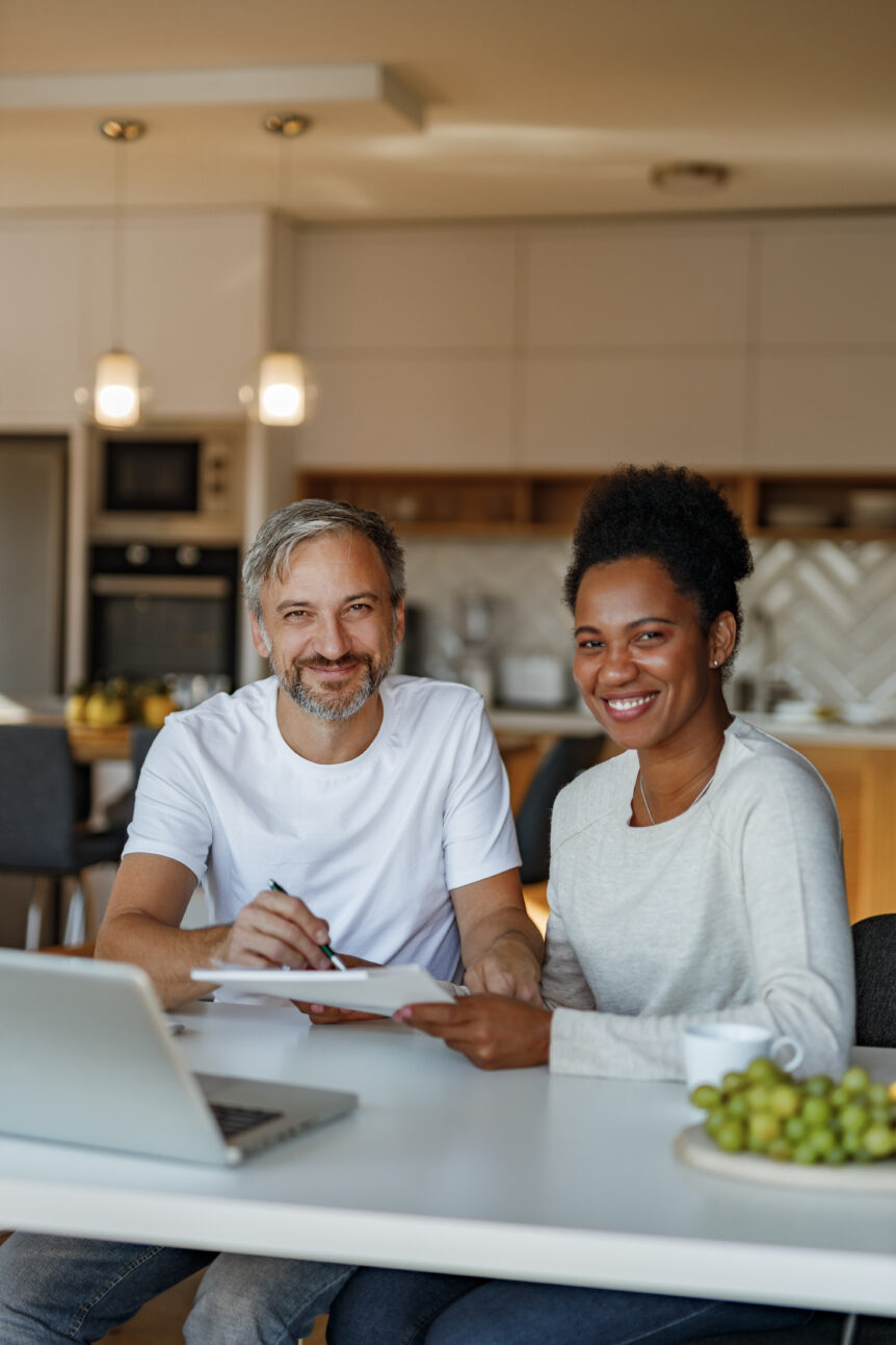 A couple reviewing financial plans, symbolizing the peace of mind achieved through SureWealth’s strategies for financial independence.