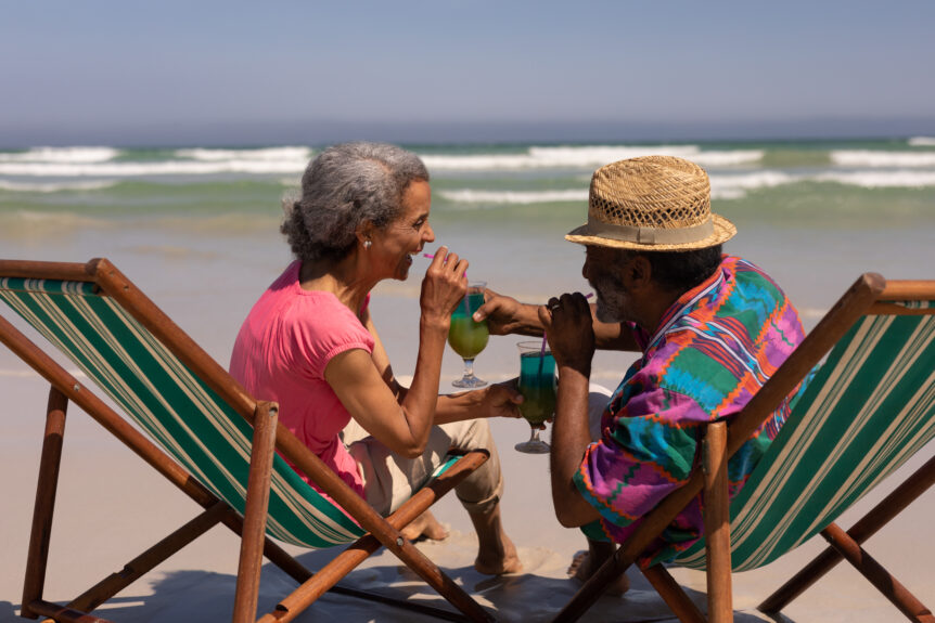 A couple enjoying drinks by the pool, symbolizing financial freedom and consistent cash flow generated through SureWealth’s strategies.